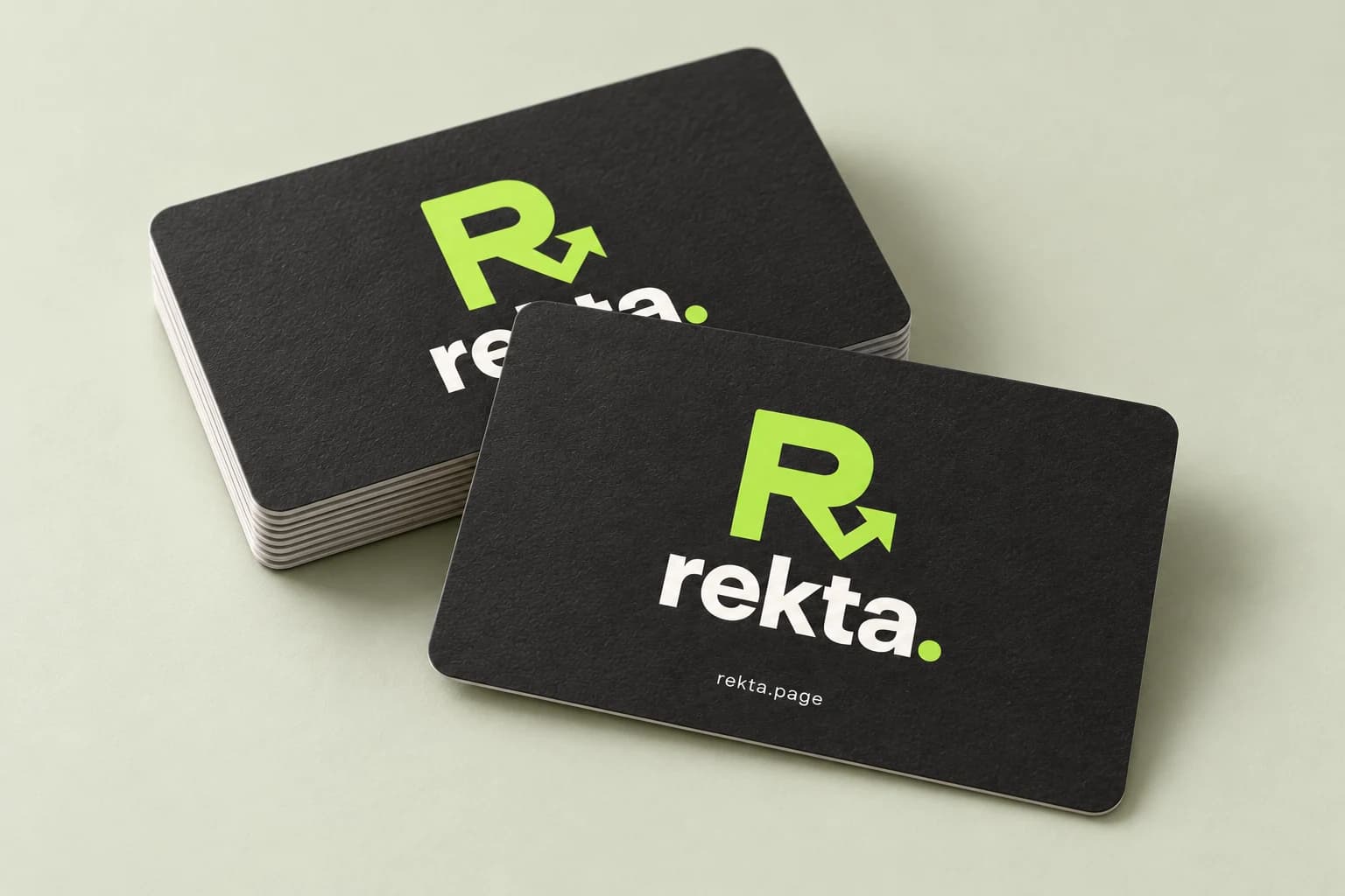 A stack of Rekta business cards on a sage surface, showing the brand design as an example.